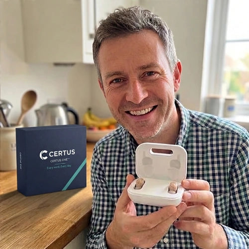 A man in his fifties holding the Certus case in his kitchen